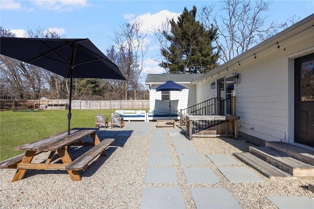 view of patio / terrace with entry steps, an outdoor structure, and fence