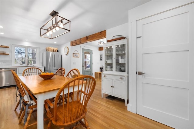 dining space featuring light wood-style floors, recessed lighting, and plenty of natural light