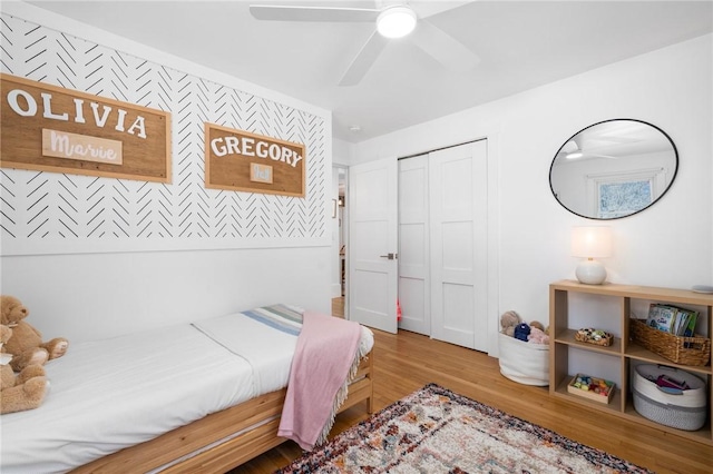 bedroom featuring a closet, a ceiling fan, and wood finished floors