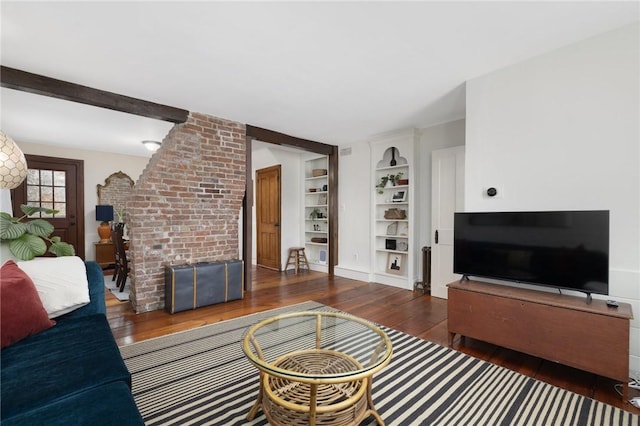 living room featuring hardwood / wood-style floors, a fireplace, and built in features