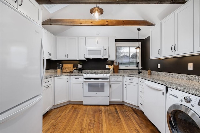 kitchen featuring washer / dryer, white appliances, white cabinets, and a sink