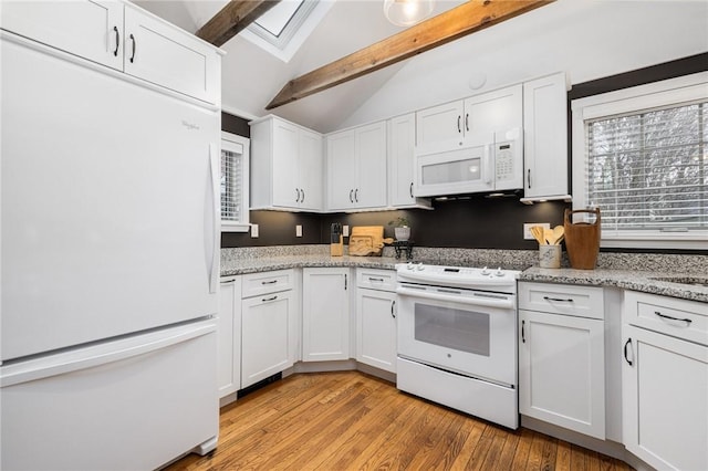 kitchen with lofted ceiling with skylight, white appliances, white cabinets, and light wood finished floors