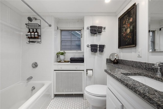 bathroom with toilet, vanity, ornamental molding, and bathing tub / shower combination