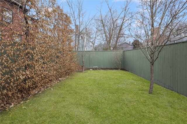 view of yard with a fenced backyard