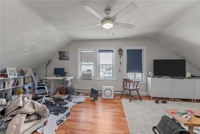 interior space with lofted ceiling, ceiling fan, baseboards, and wood finished floors