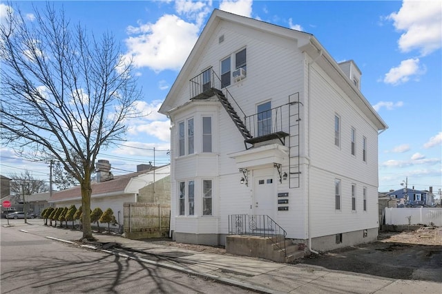 view of property exterior featuring cooling unit and fence