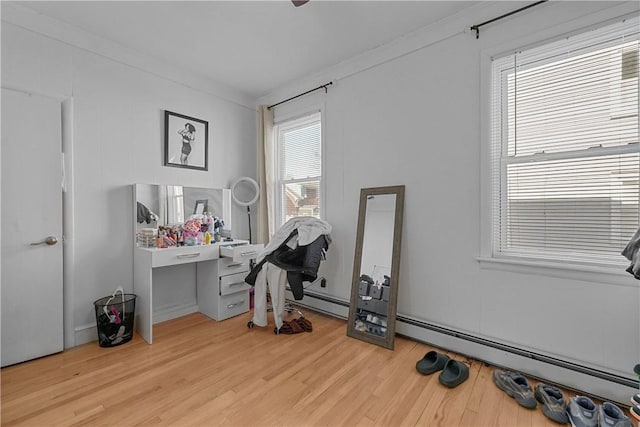 home office with wood finished floors and crown molding