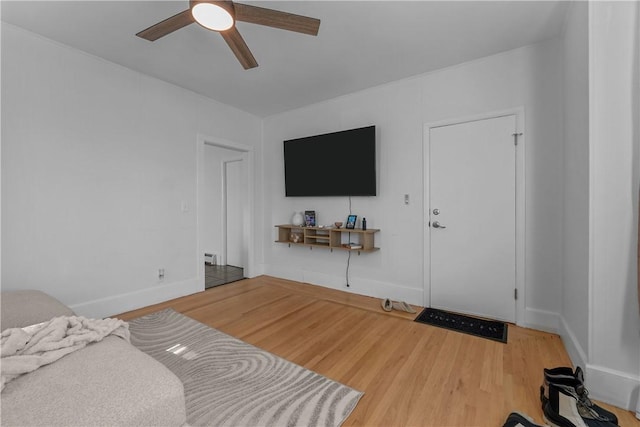 bedroom featuring ceiling fan, baseboards, and wood finished floors