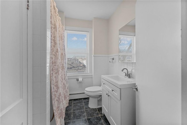 bathroom with toilet, curtained shower, tile patterned flooring, baseboard heating, and vanity