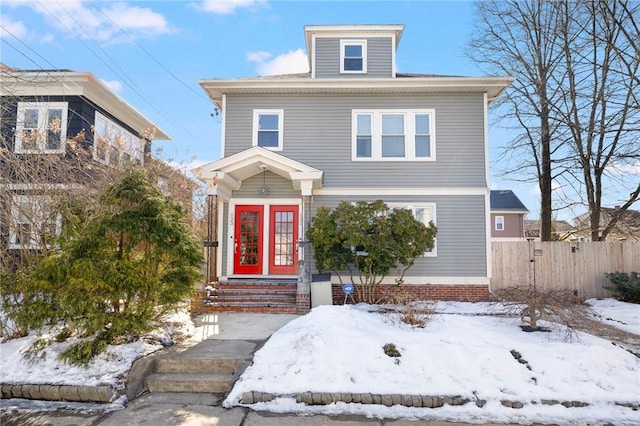 american foursquare style home featuring fence