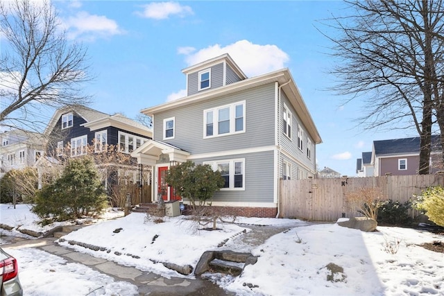 american foursquare style home featuring fence