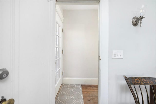 interior space with wood finished floors and baseboards