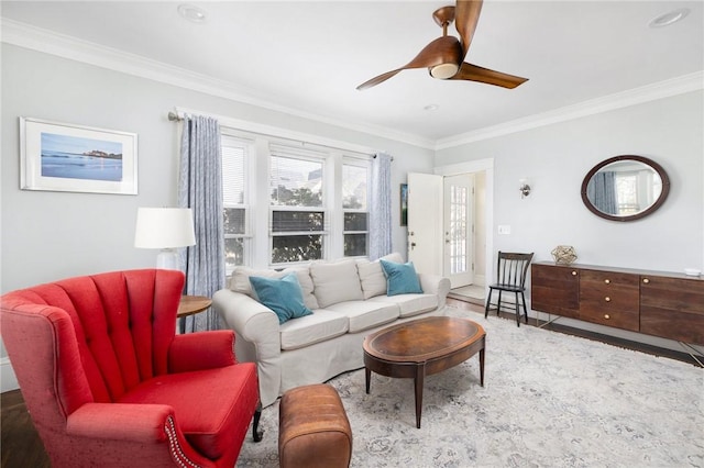 living area featuring ornamental molding and ceiling fan