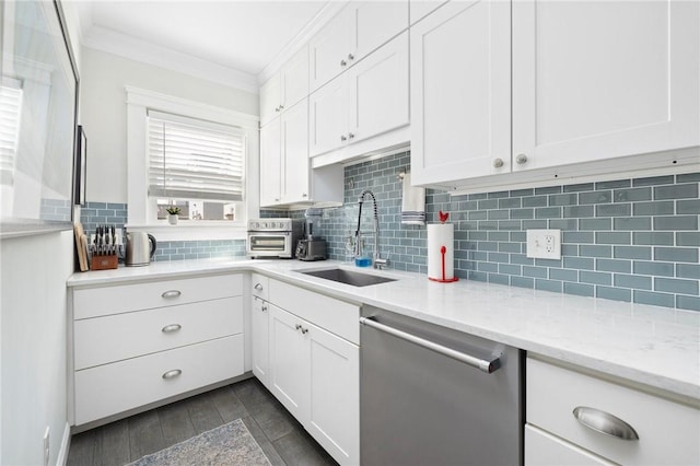 kitchen with crown molding, white cabinets, dishwasher, and a sink