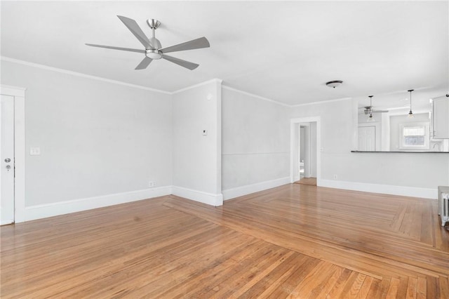 unfurnished living room with crown molding, ceiling fan, light wood-type flooring, and baseboards