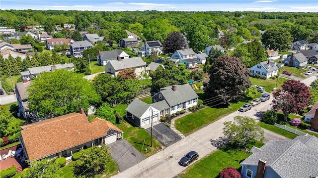 drone / aerial view featuring a residential view and a wooded view