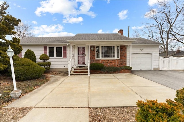 single story home featuring an attached garage, brick siding, fence, driveway, and a chimney