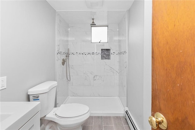 full bath with a baseboard heating unit, a tile shower, vanity, and toilet