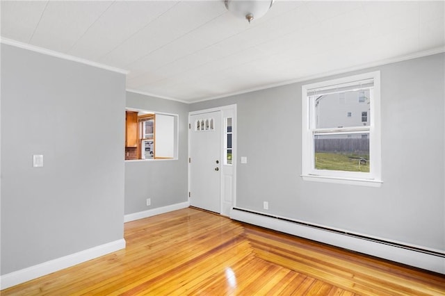 unfurnished room with light wood-style floors, a baseboard radiator, baseboards, and ornamental molding