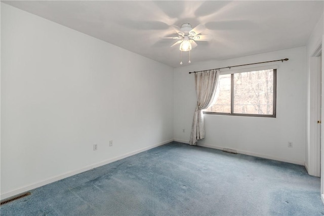 empty room with ceiling fan, carpet flooring, visible vents, and baseboards