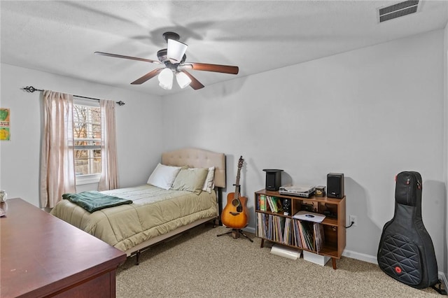 carpeted bedroom featuring baseboards, visible vents, and a ceiling fan