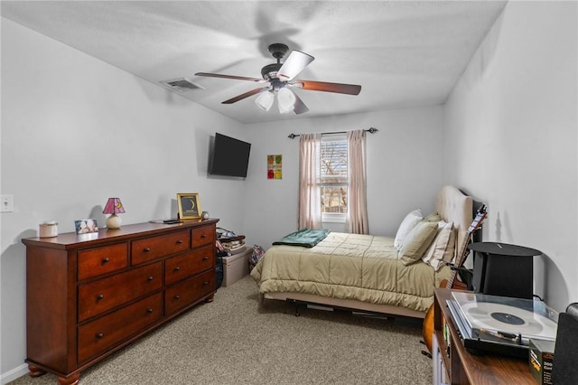 bedroom featuring a ceiling fan, light colored carpet, and visible vents