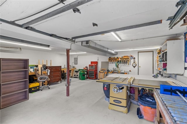 garage with a workshop area and electric panel