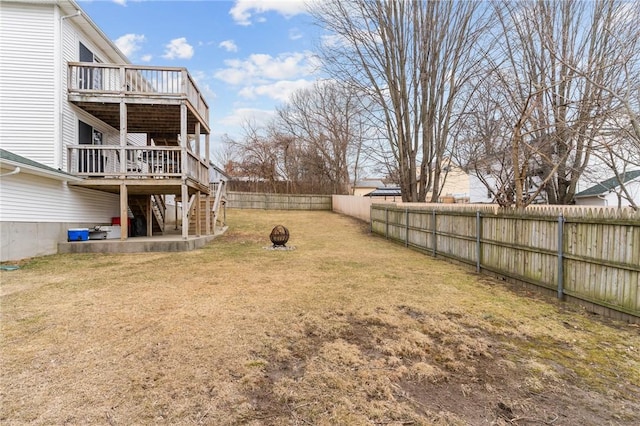 view of yard with a fenced backyard, stairs, a fire pit, and a deck