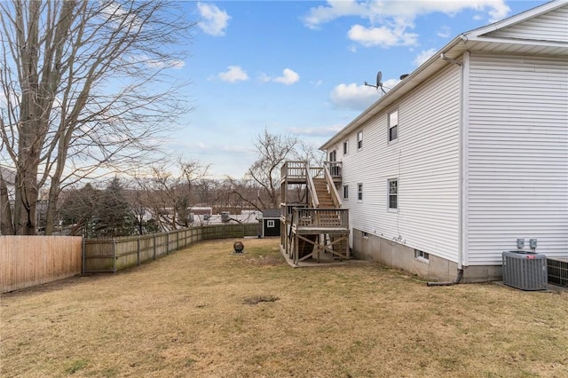 view of yard featuring stairs, a fenced backyard, and cooling unit