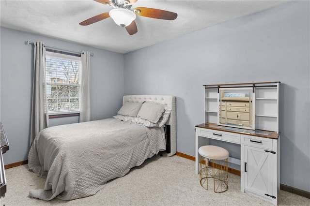 bedroom with ceiling fan, light colored carpet, and baseboards