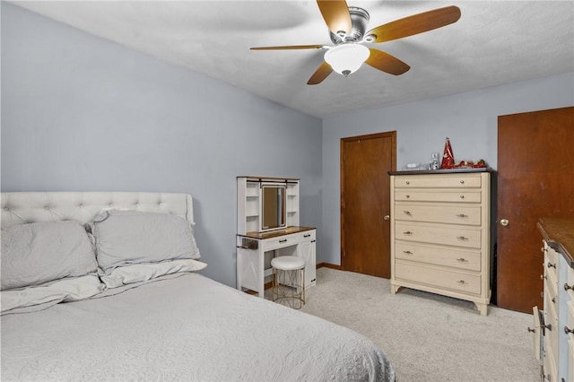 bedroom featuring ceiling fan and light colored carpet