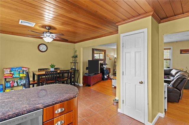 kitchen with open floor plan, light tile patterned flooring, visible vents, and crown molding