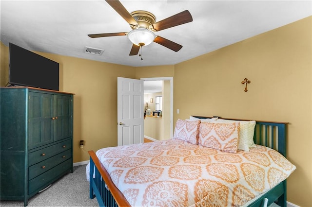 bedroom with baseboards, visible vents, a ceiling fan, and light colored carpet