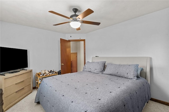 bedroom featuring light carpet, ceiling fan, and baseboards