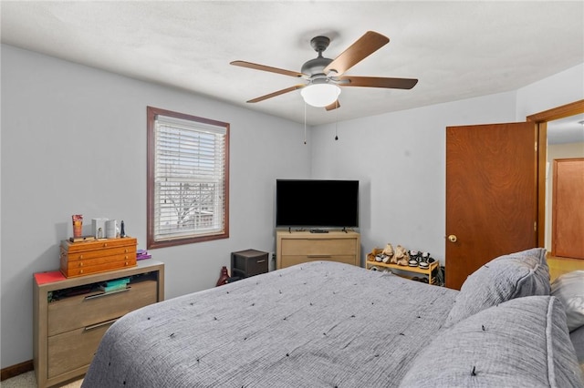 bedroom with a ceiling fan and baseboards