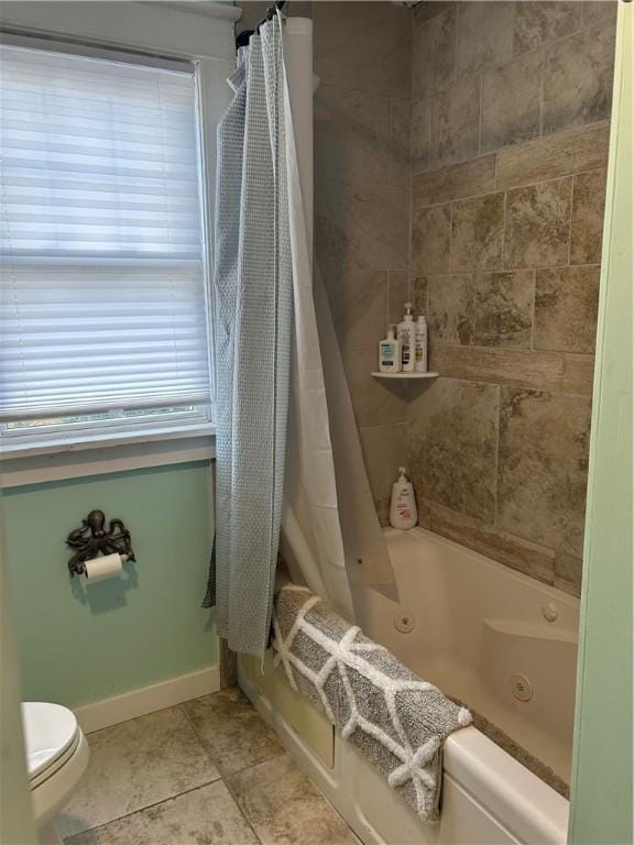 full bath with tile patterned flooring, toilet, baseboards, and a combined bath / shower with jetted tub