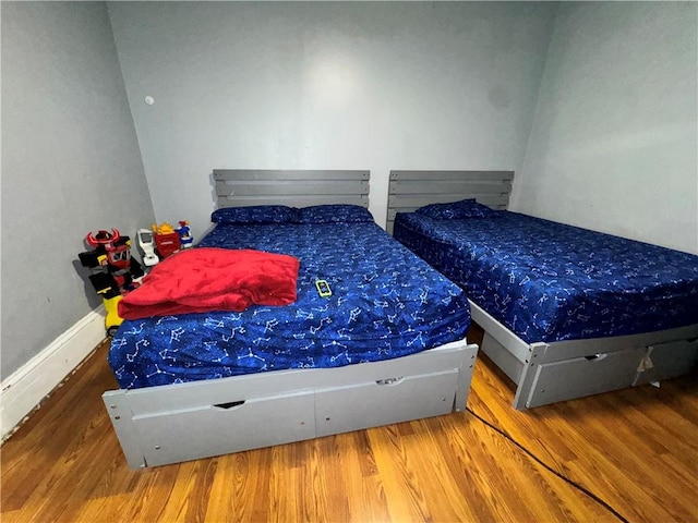 bedroom featuring wood finished floors