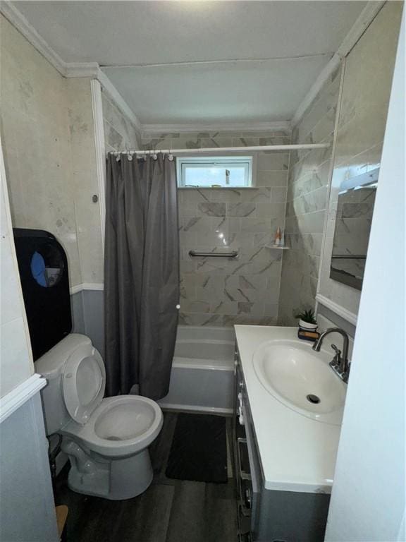 bathroom featuring toilet, shower / bath combination with curtain, and vanity