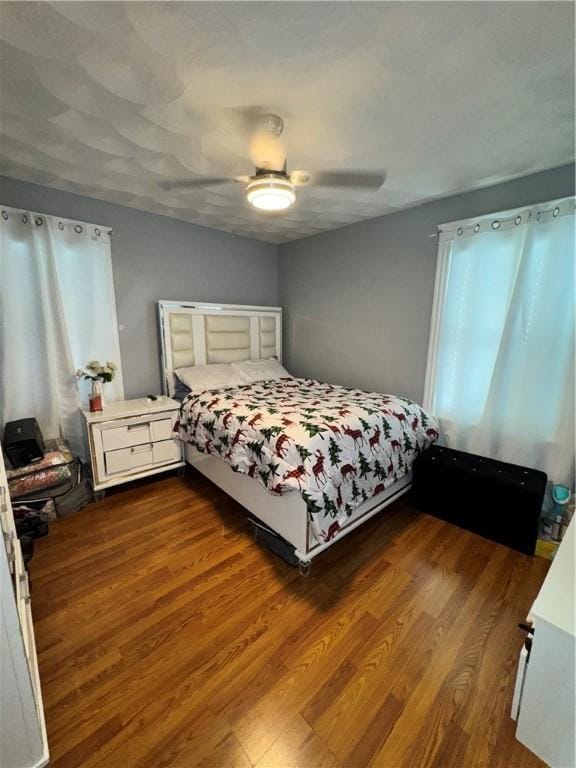 bedroom with dark wood finished floors and a ceiling fan