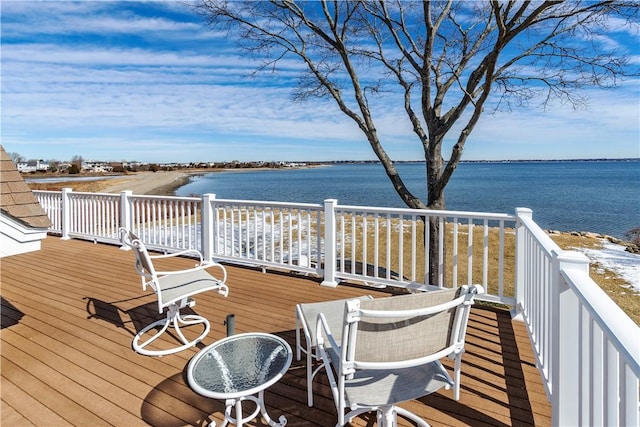 wooden deck featuring a water view