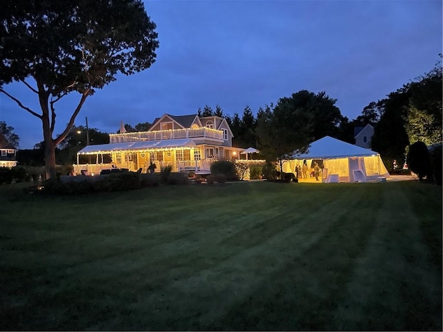 rear view of property featuring a yard