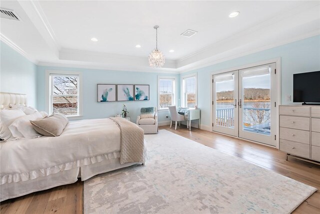 1040 Buttonwoods Ave, Warwick, RI 02886 - bedroom featuring crown molding, french doors, a tray ceiling, access to exterior, and wood finished floors