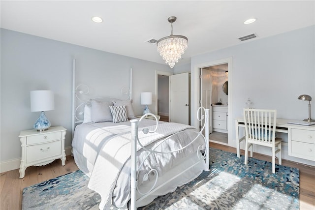 bedroom featuring wood finished floors, visible vents, and recessed lighting