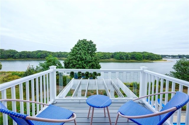 wooden terrace featuring a water view