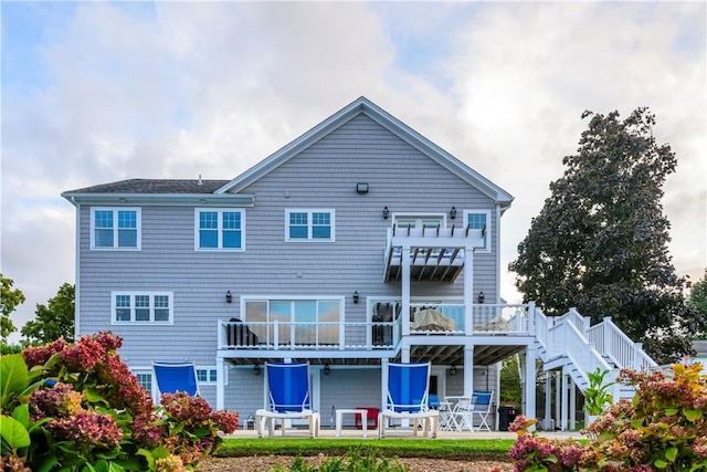 back of house featuring a patio area and stairway