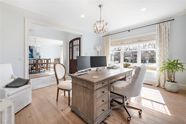 office space featuring ornamental molding, recessed lighting, light wood-style floors, and a notable chandelier