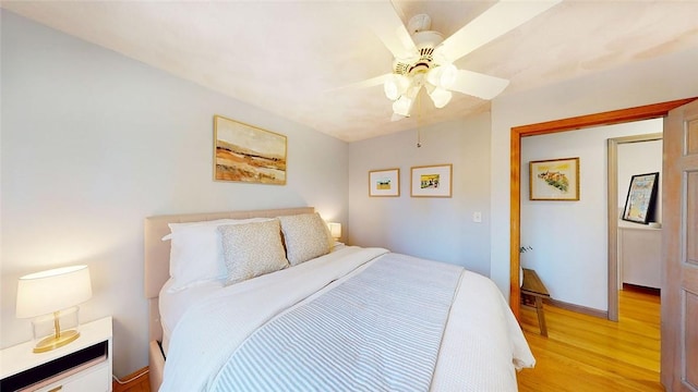 bedroom featuring baseboards, ceiling fan, and light wood finished floors