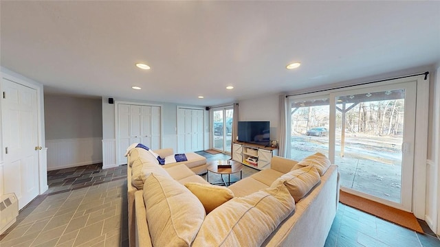 living area featuring recessed lighting and a wainscoted wall