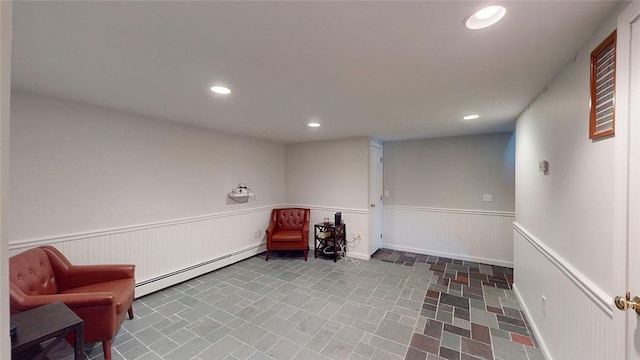 sitting room with recessed lighting, a baseboard heating unit, and wainscoting