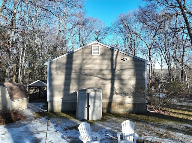 view of side of home with a detached carport